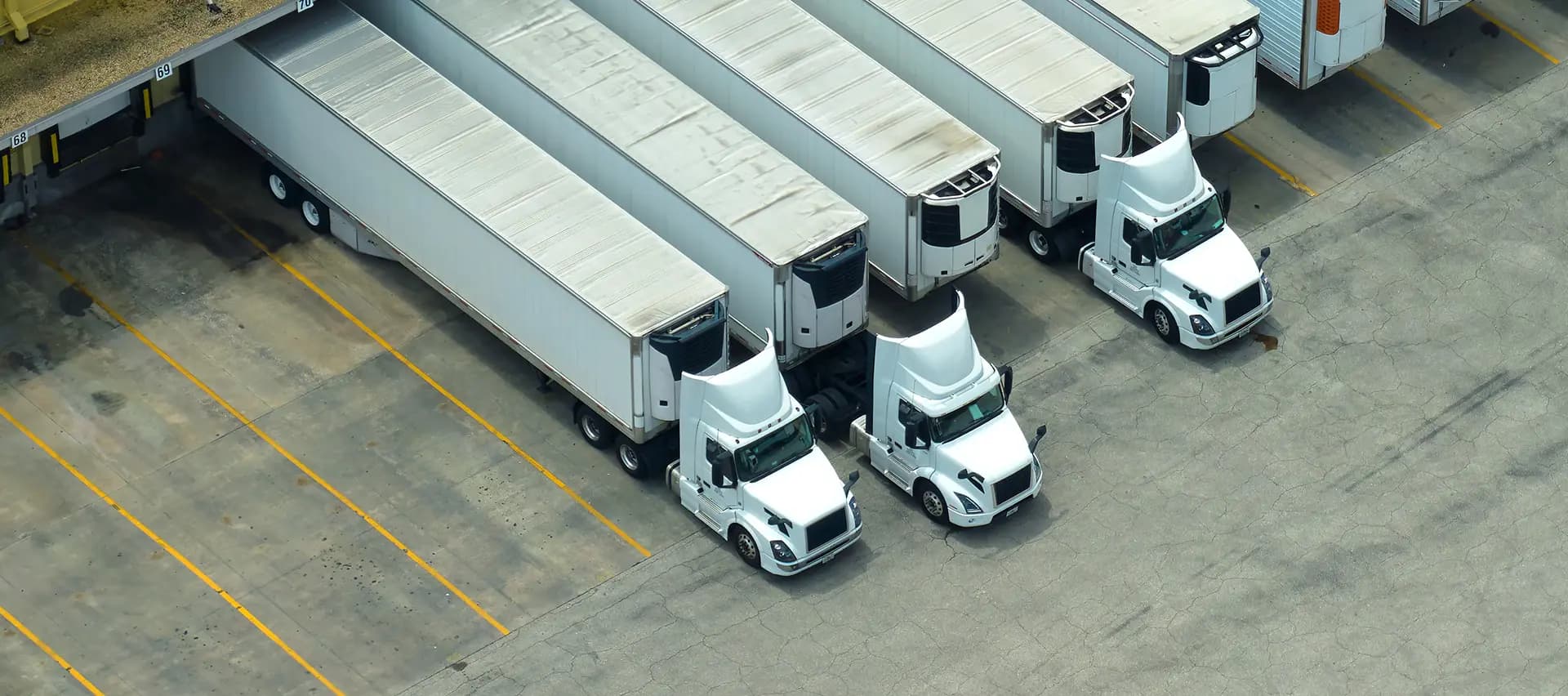 A view of a fleet of trucks parked in a lot, showing the need for proper maintenance and torque tools.