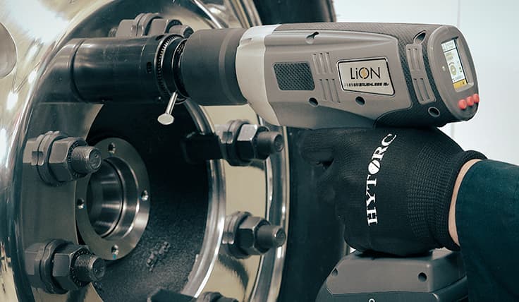 The LION GUN Electric Torque Tool with the HYTORC GRIP-TIGHT™ Nut Driver, shown overtop a GRIP-TIGHT™ Nut on a wheel application.
