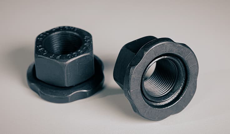 Two GRIP-TIGHT™ Nuts side-by-side, showing the interior threads and the top of the nut.