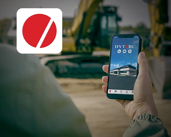 A hand using the HYTORC Mobile App on a construction site